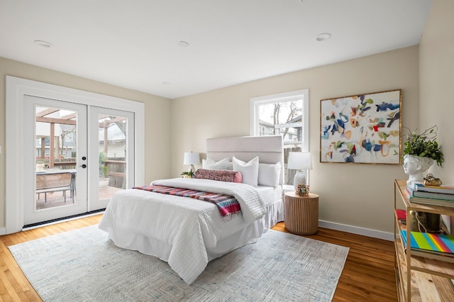 bedroom featuring hardwood / wood-style floors, access to exterior, and french doors