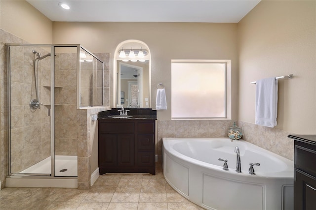 bathroom featuring independent shower and bath, tile patterned floors, and vanity