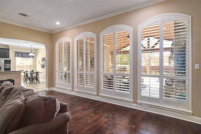 doorway featuring hardwood / wood-style floors and crown molding