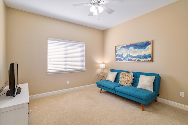 living area with ceiling fan and light colored carpet