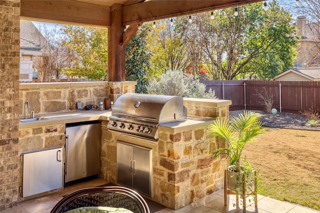 view of patio / terrace with exterior kitchen, sink, and grilling area