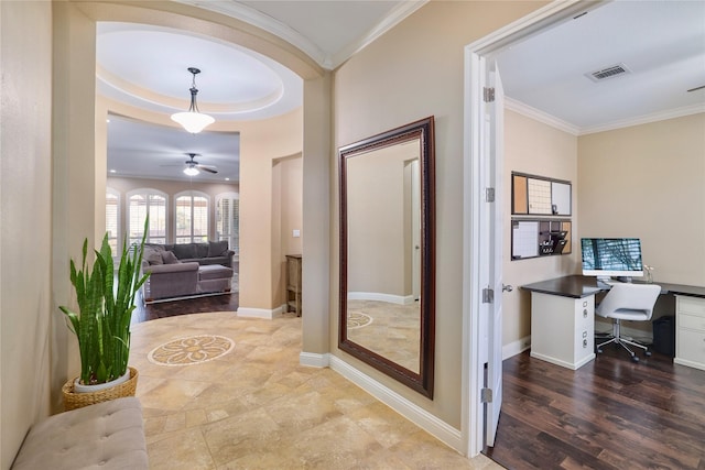 hallway featuring hardwood / wood-style floors, a tray ceiling, and crown molding