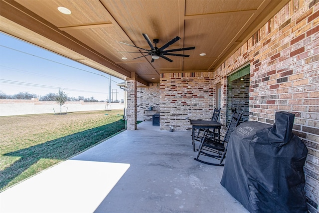 view of patio with ceiling fan and a grill