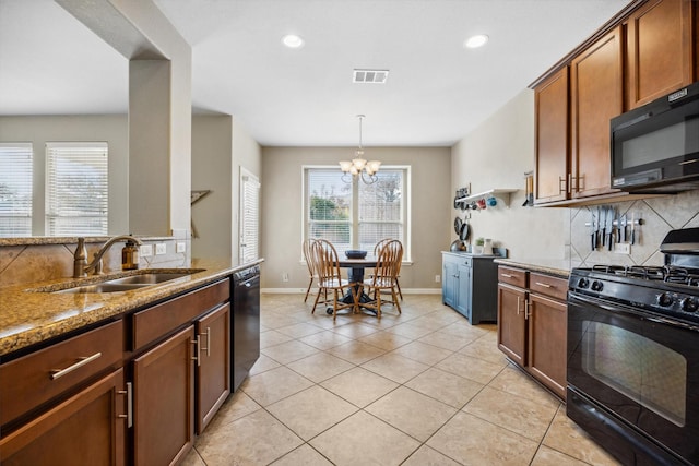 kitchen featuring black appliances, an inviting chandelier, sink, and light stone counters