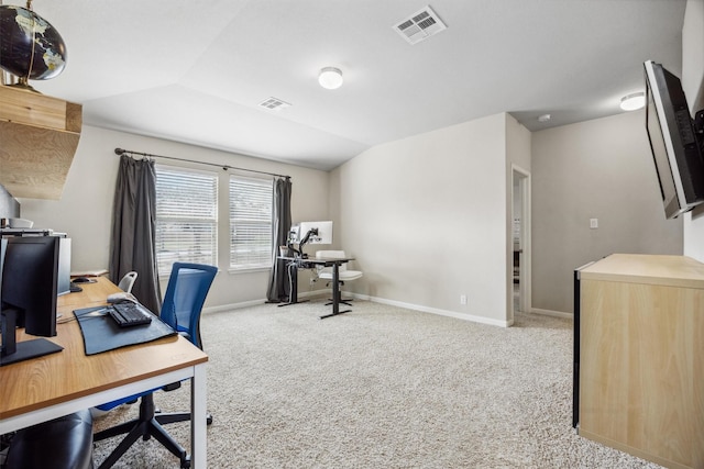 carpeted office space featuring lofted ceiling