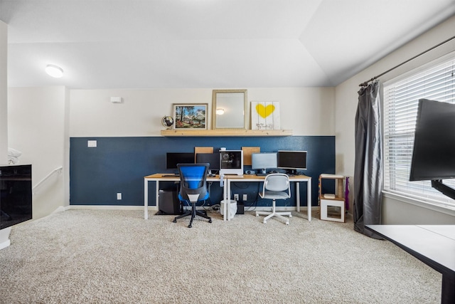 carpeted office space featuring lofted ceiling and a healthy amount of sunlight