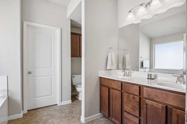 bathroom featuring toilet and vanity