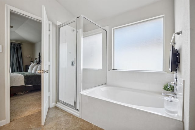 bathroom with lofted ceiling and separate shower and tub