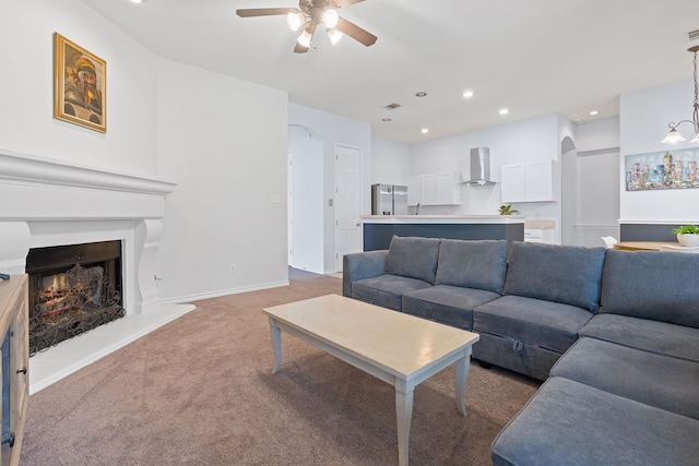 carpeted living room featuring ceiling fan