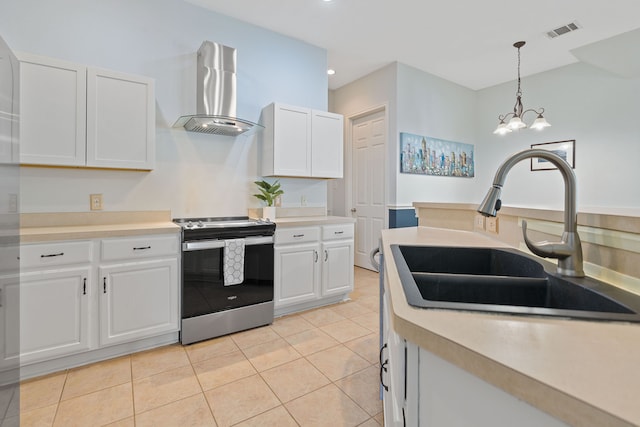 kitchen with sink, stainless steel stove, white cabinets, and exhaust hood