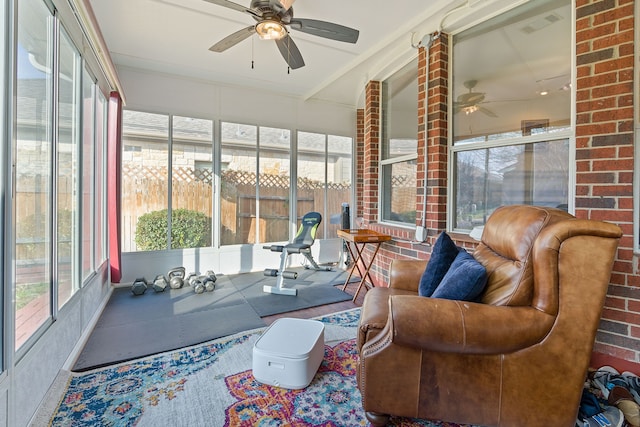 sunroom / solarium featuring ceiling fan