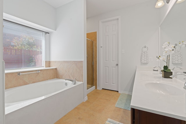 bathroom featuring tile patterned floors, vanity, and shower with separate bathtub