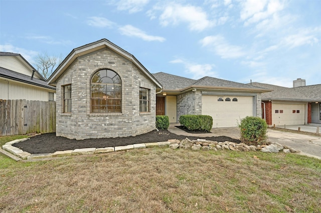 view of front of home with a front yard and a garage