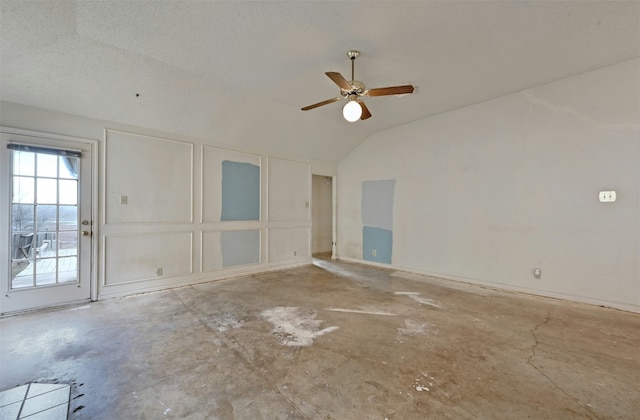 empty room with ceiling fan and vaulted ceiling