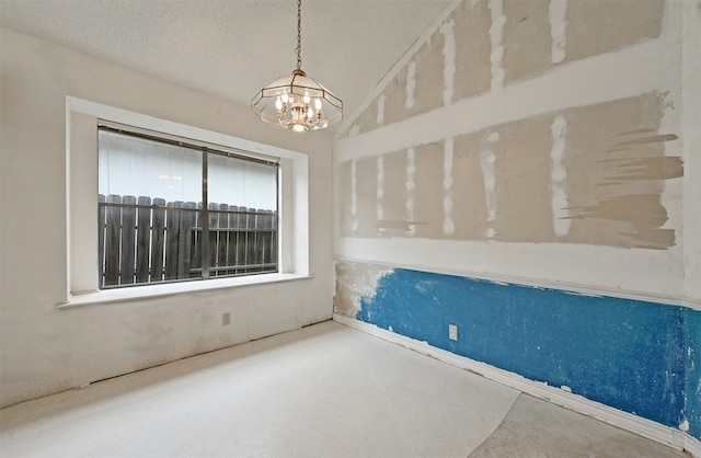 empty room featuring a chandelier