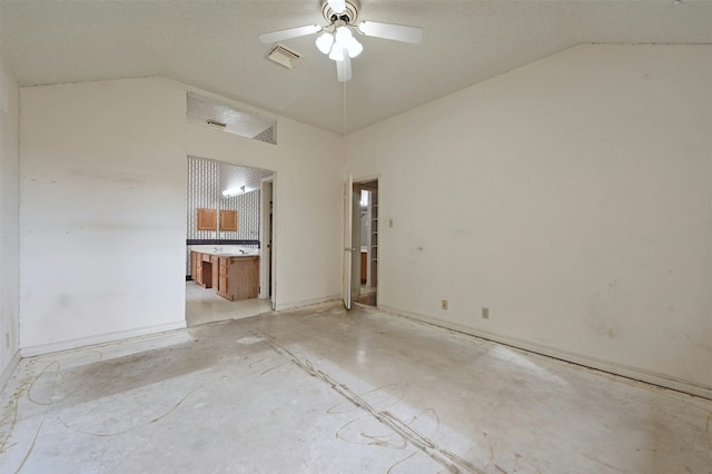 unfurnished room featuring ceiling fan and vaulted ceiling