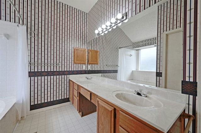 bathroom featuring shower / bath combo with shower curtain and vanity