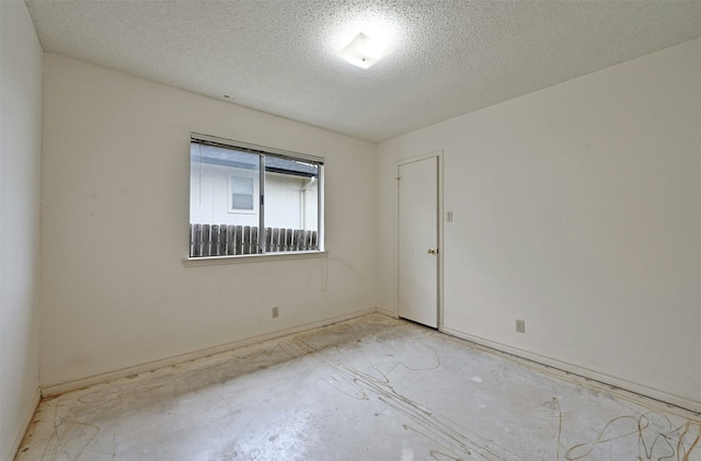 empty room with a textured ceiling