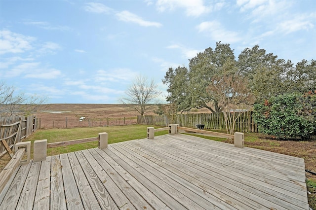 deck featuring a yard and a rural view