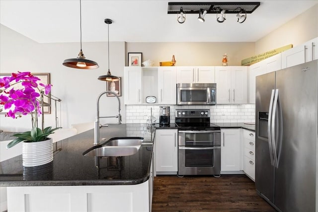 kitchen with dark hardwood / wood-style floors, decorative backsplash, hanging light fixtures, stainless steel appliances, and white cabinets