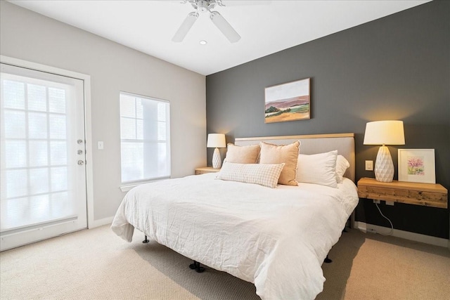 carpeted bedroom featuring ceiling fan and access to outside