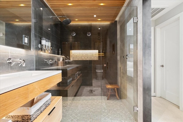 bathroom with an enclosed shower, vanity, tile walls, toilet, and wooden ceiling