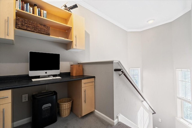 office space featuring built in desk, a wealth of natural light, and crown molding