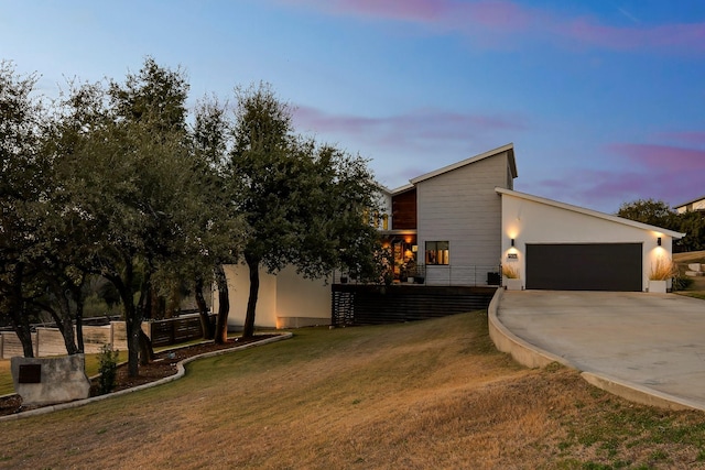 modern home with a garage and a lawn