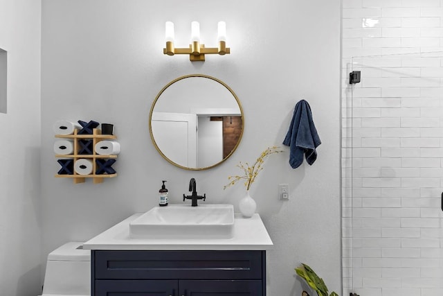 bathroom with vanity, an enclosed shower, and toilet