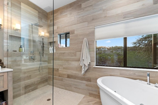 bathroom featuring a healthy amount of sunlight and separate shower and tub