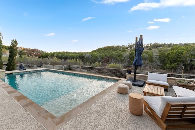 view of swimming pool with a patio area