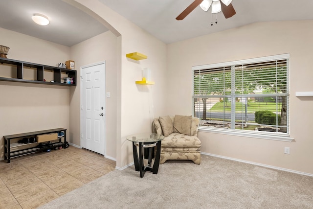 living area featuring ceiling fan, vaulted ceiling, and light tile patterned flooring