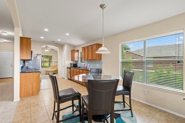 tiled dining room featuring ceiling fan and a wealth of natural light