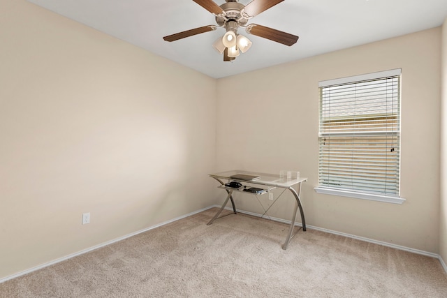 carpeted spare room with ceiling fan