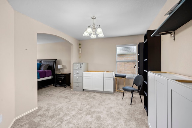 laundry room featuring light carpet and a chandelier