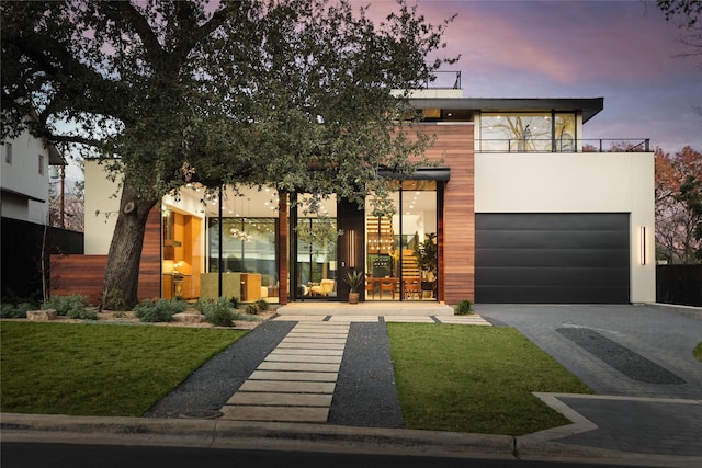 modern home with a balcony and a yard