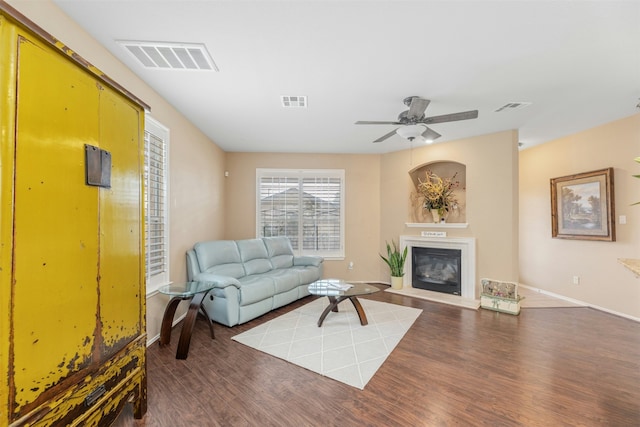 living room with ceiling fan and dark hardwood / wood-style floors