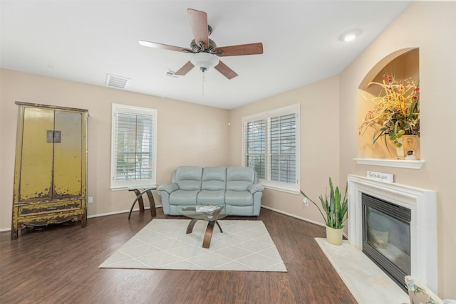 living room featuring ceiling fan, plenty of natural light, and dark hardwood / wood-style floors