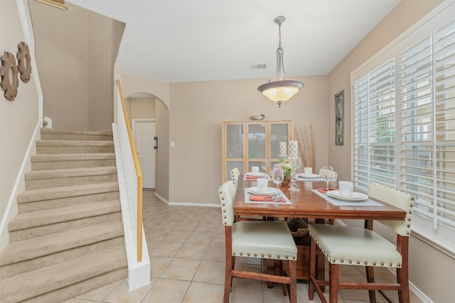 dining space featuring light tile patterned flooring