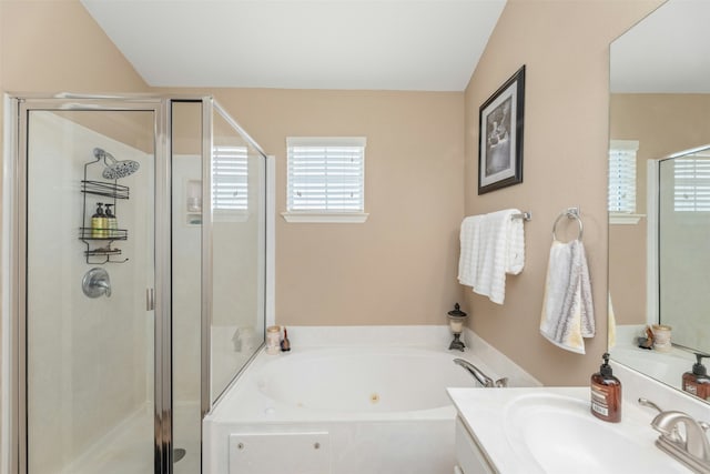 bathroom featuring lofted ceiling, vanity, and shower with separate bathtub