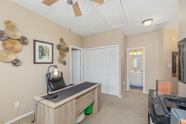 office featuring light carpet, ceiling fan, and sink