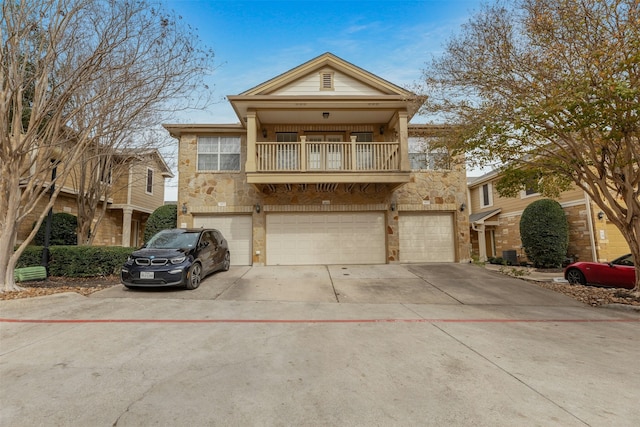 view of front of house with a garage, a balcony, and central AC