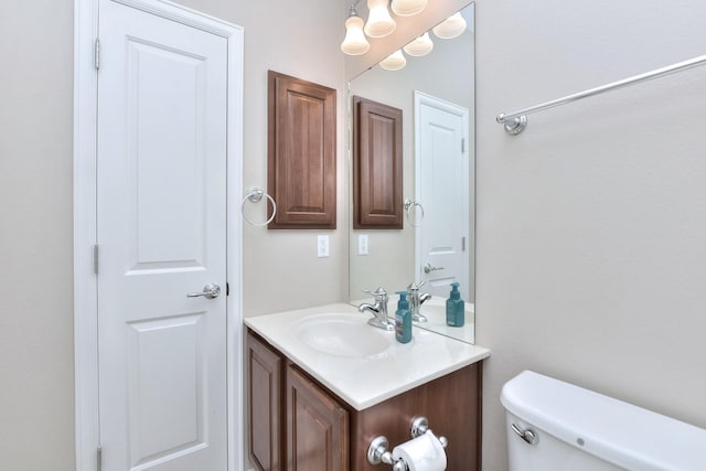 bathroom with toilet and vanity