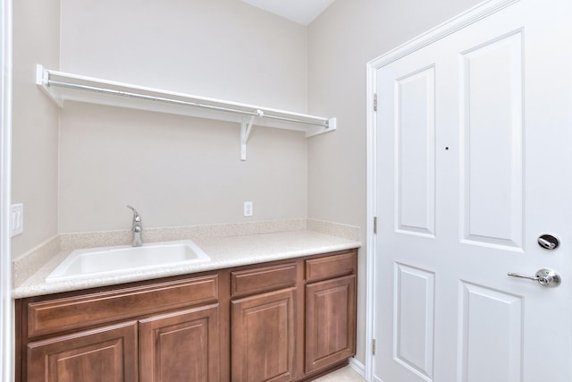 clothes washing area featuring sink