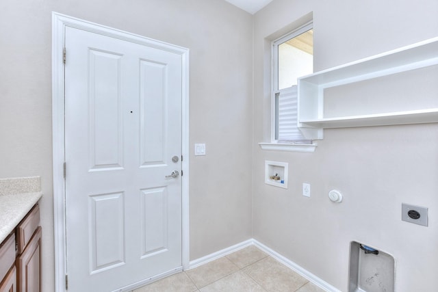 washroom with electric dryer hookup, light tile patterned flooring, hookup for a washing machine, cabinets, and gas dryer hookup