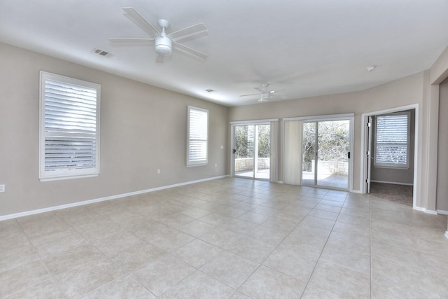 tiled empty room with ceiling fan