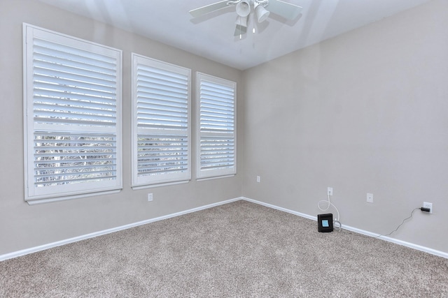 carpeted spare room featuring ceiling fan