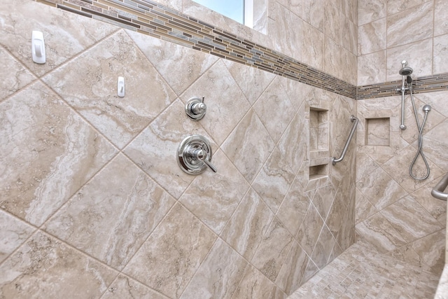 interior details featuring tiled shower