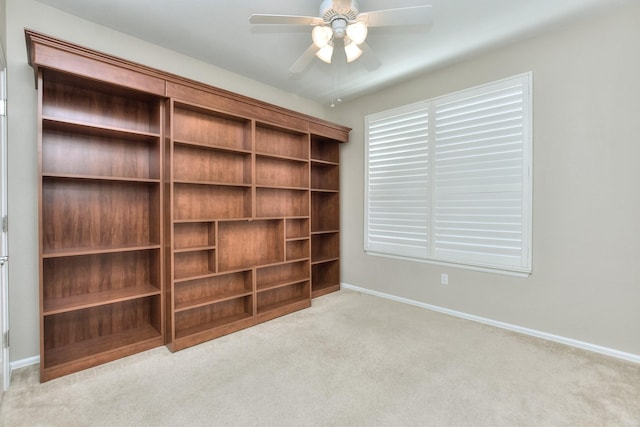 interior space with ceiling fan and light colored carpet