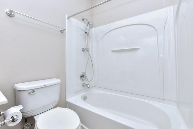 bathroom featuring shower / tub combination and toilet